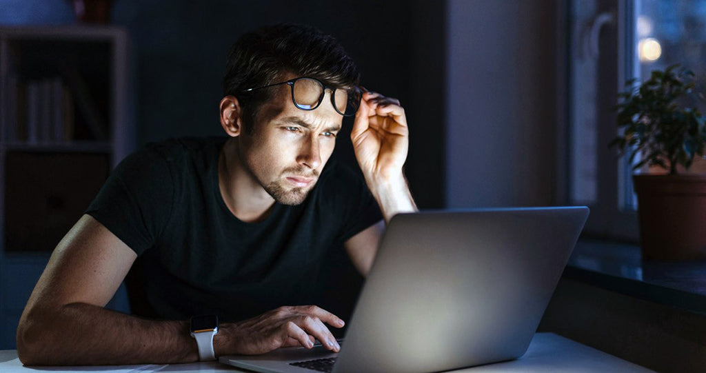 man staring a computer screen with strained eyes