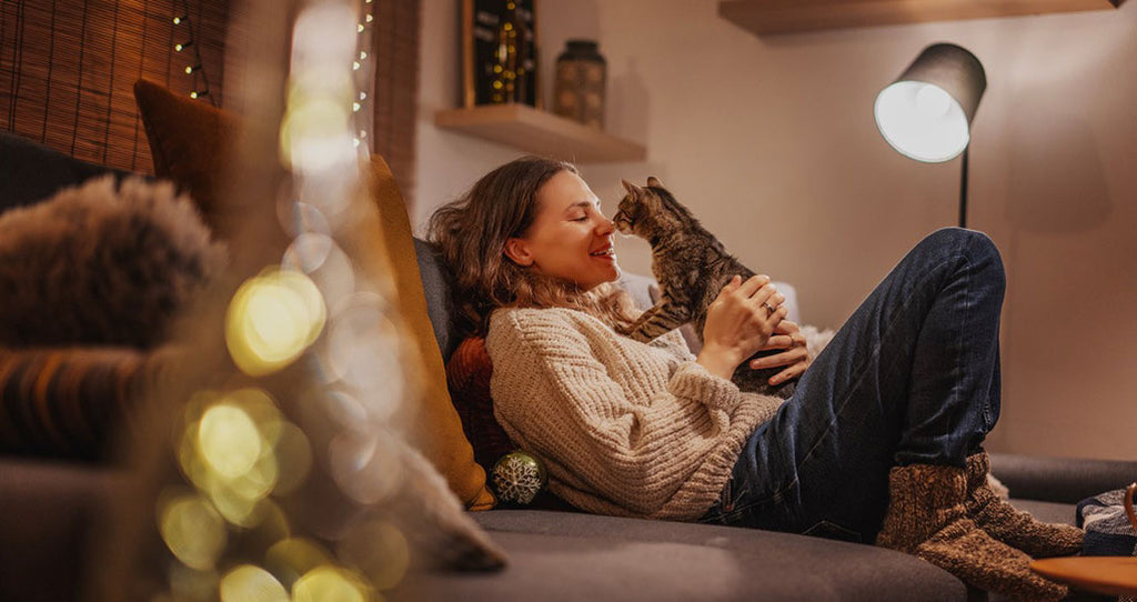 Woman cuddles with her cat while enjoying a digital detox