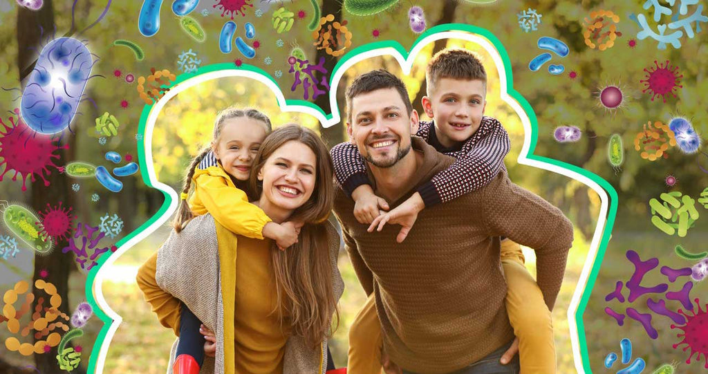 Family of four walking in the park with a protective barrier around them surrounded by germs on the outside to show immune strength