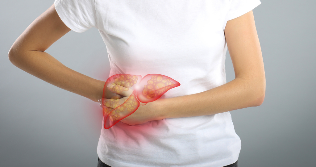 Woman holding her abdomen with hovering image of liver suffering from fatty liver disease