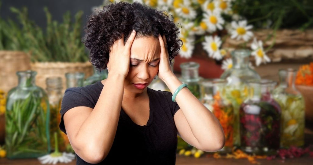 Stress out woman with calming herbs such as chamomile in the background