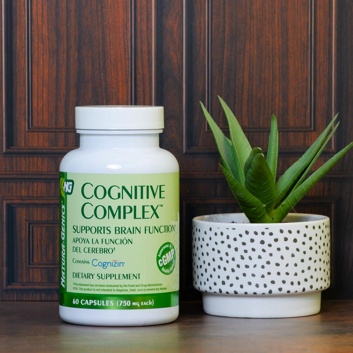 Bottle of Cognitive Complex, supplement formulated to promote brain health and function next to a small plant