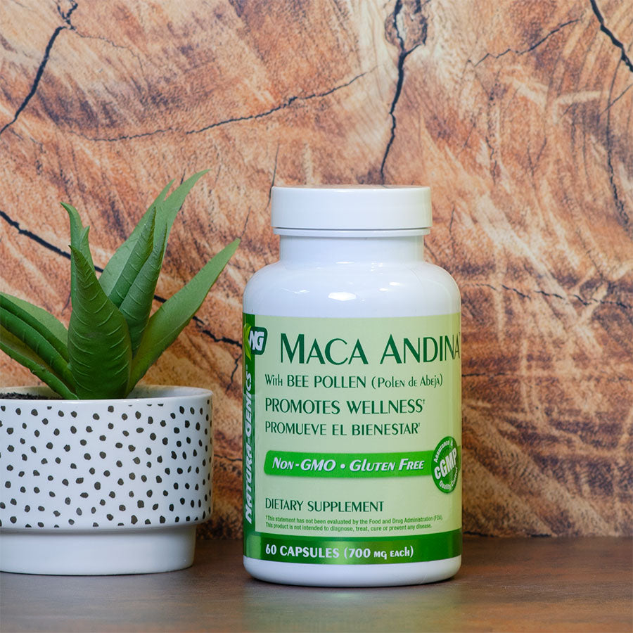 Bottle of Maca supplement with bee pollen next to a small potted plant 